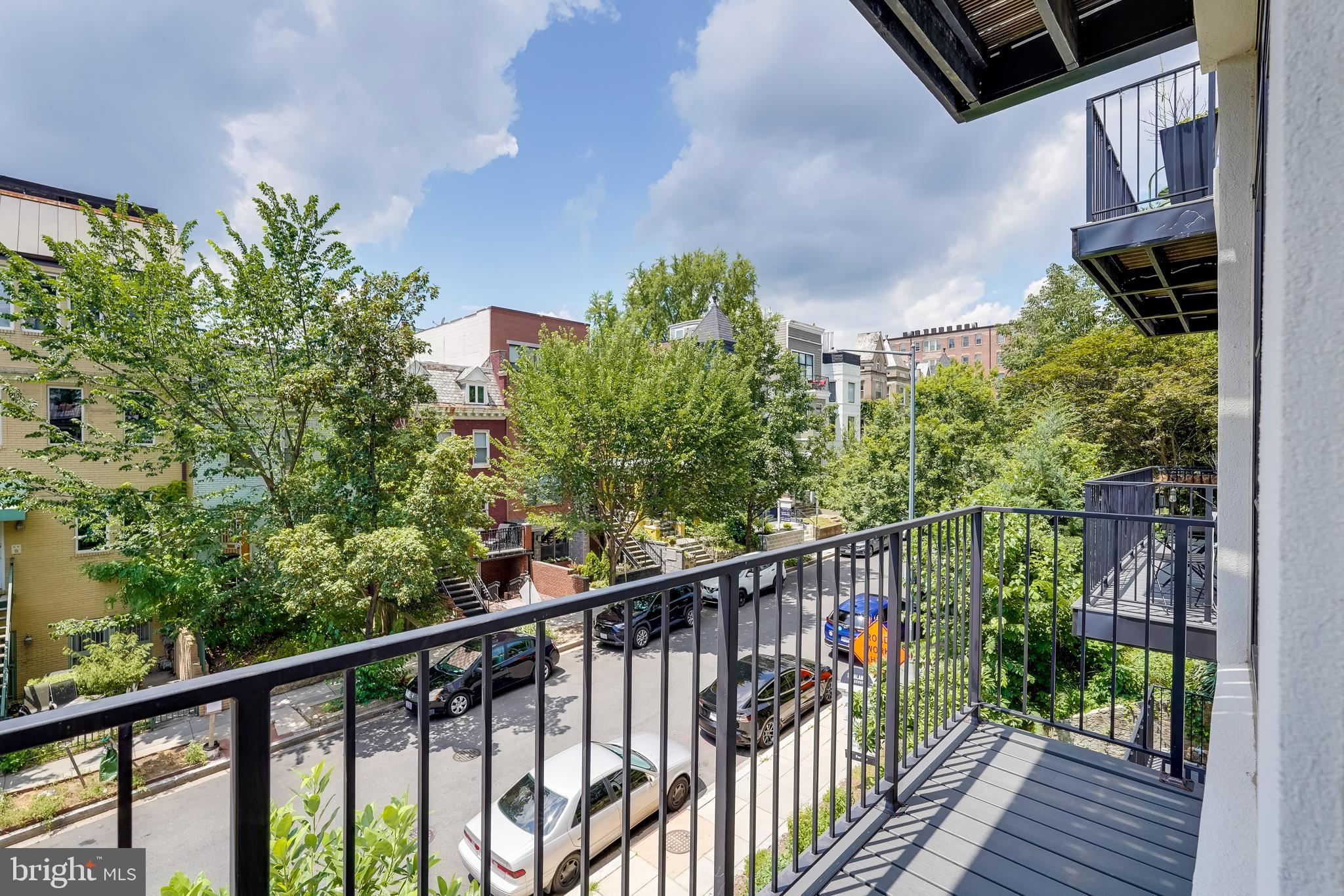 2419 Ontario Road Northwest, Unit 202 Washington, DC 20009 - Photo 7 of 15 a view of balcony with wooden floor and fence