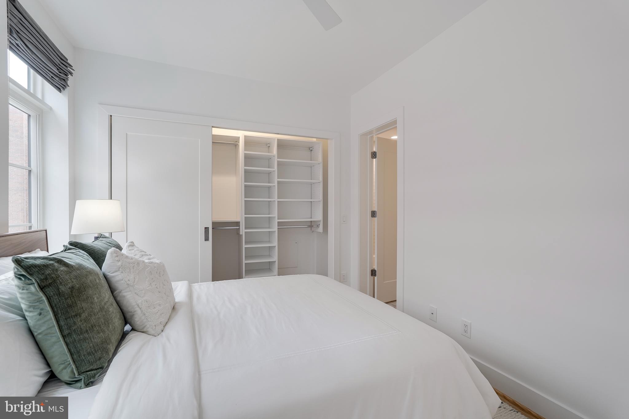 2419 Ontario Road Northwest, Unit 202 Washington, DC 20009 - Photo 10 of 15 a bedroom with a bed and a window