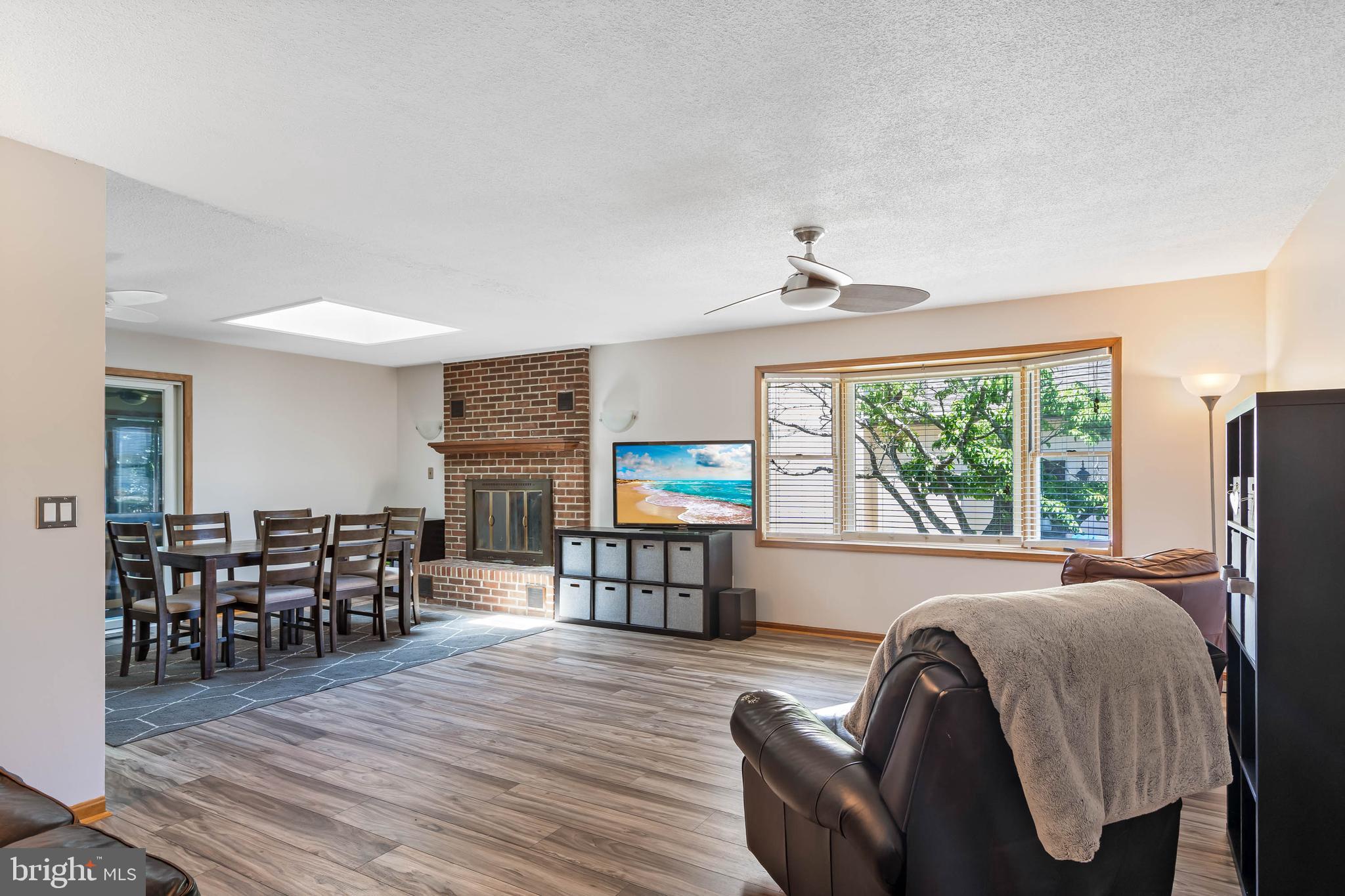 521 Harbor Road Ocean View, DE 19970 - Photo 12 of 46 a living room with furniture and a flat screen tv with wooden floor