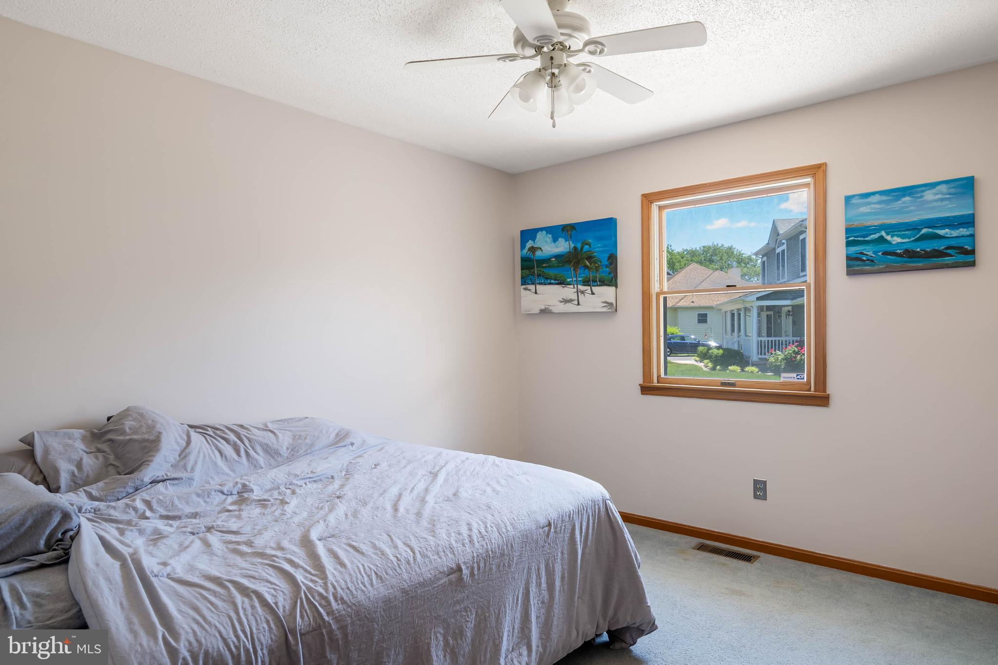 521 Harbor Road Ocean View, DE 19970 - Photo 20 of 46 a bedroom with a bed and a painting on the wall