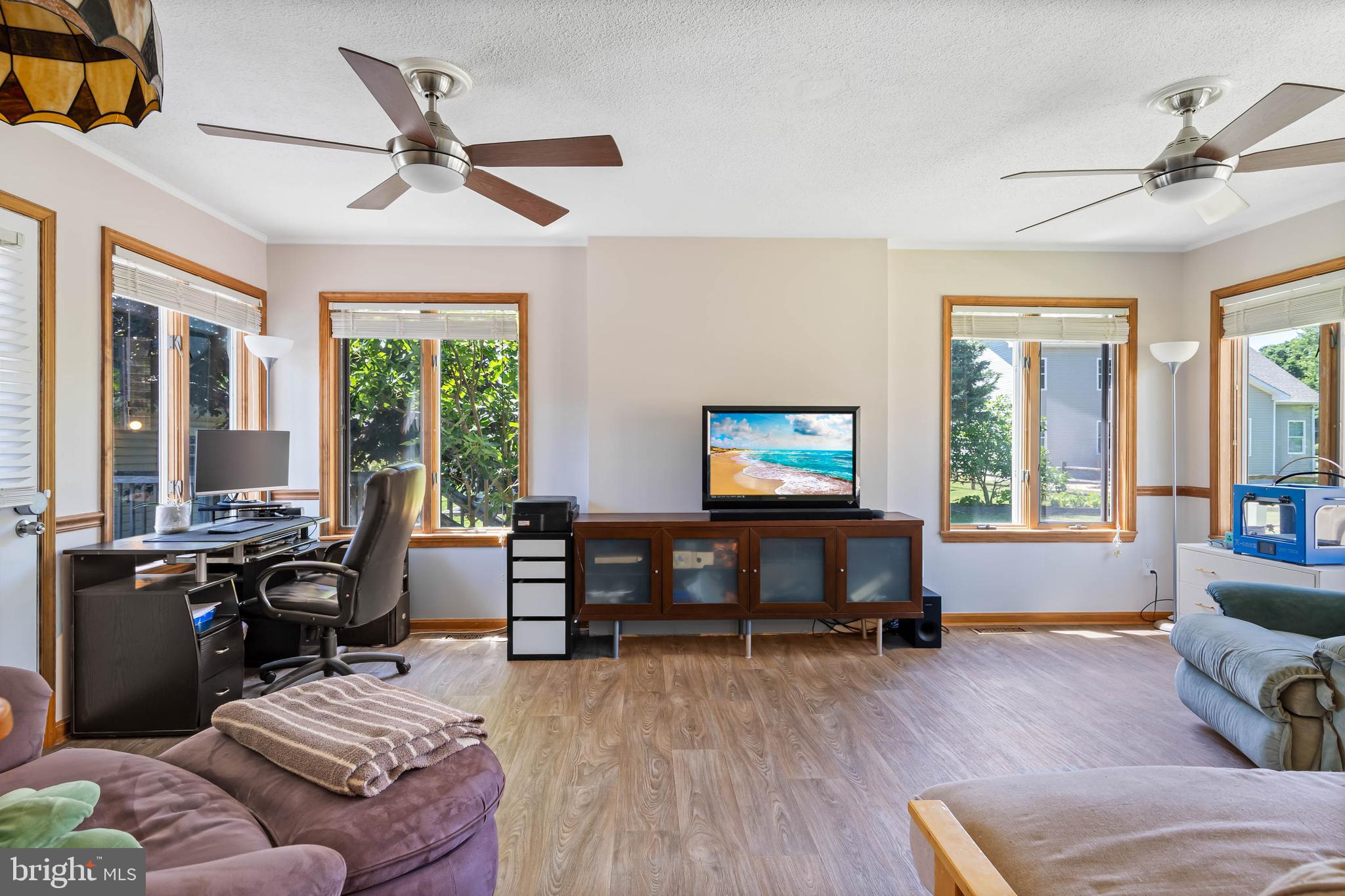 521 Harbor Road Ocean View, DE 19970 - Photo 23 of 46 a living room with furniture and a flat screen tv with wooden floor