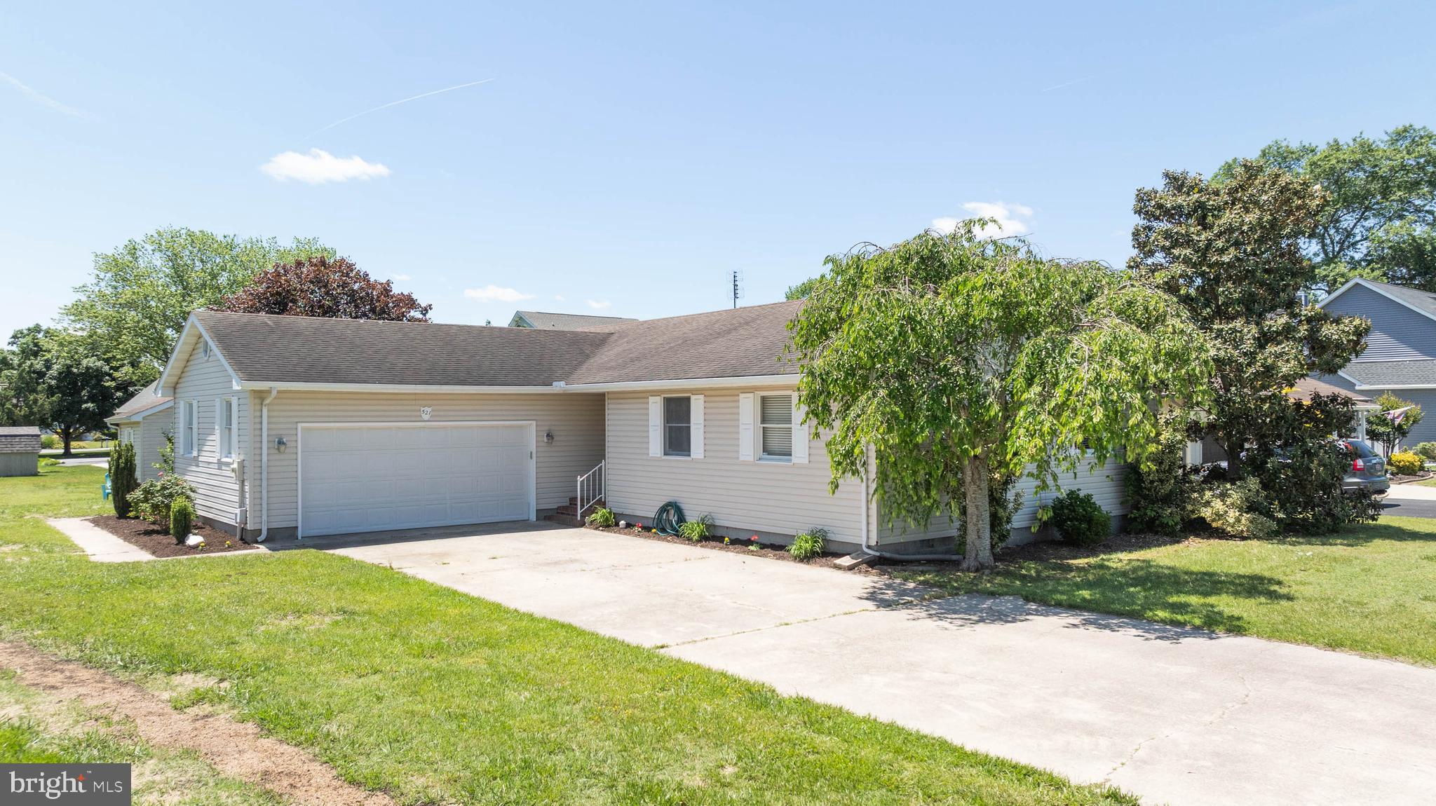 521 Harbor Road Ocean View, DE 19970 - Photo 28 of 46 a front view of a house with a yard and garage