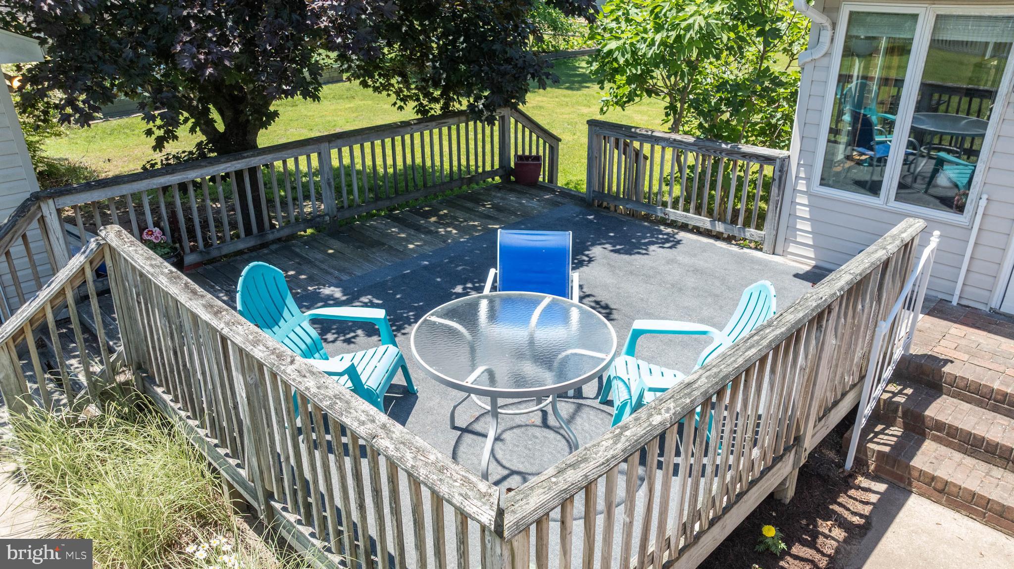 521 Harbor Road Ocean View, DE 19970 - Photo 32 of 46 a balcony with wooden floor stairs and wooden fence