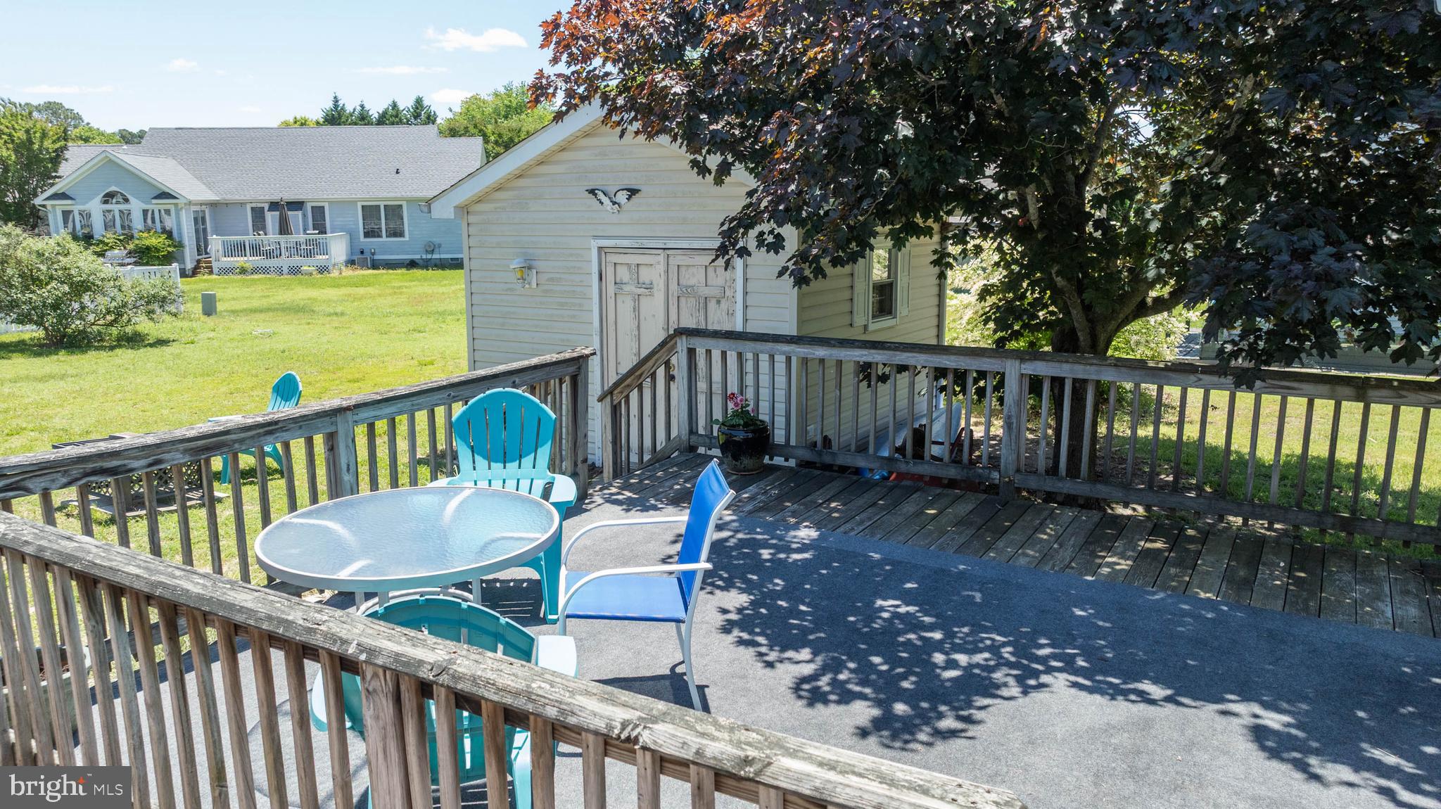 521 Harbor Road Ocean View, DE 19970 - Photo 33 of 46 a view of a wooden deck and a garden