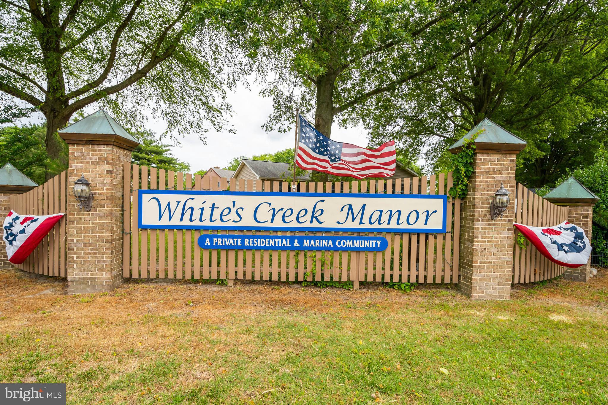 521 Harbor Road Ocean View, DE 19970 - Photo 43 of 46 a view of outdoor space with signage and flags