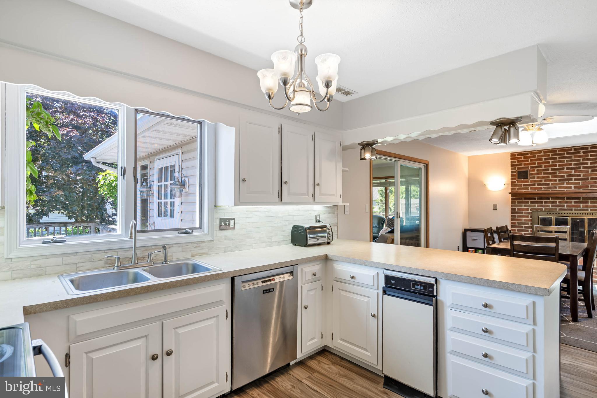 521 Harbor Road Ocean View, DE 19970 - Photo 5 of 46 a kitchen with a sink stove and cabinets