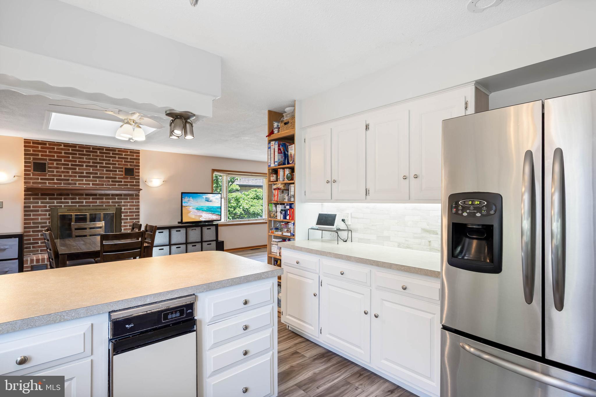 521 Harbor Road Ocean View, DE 19970 - Photo 6 of 46 a kitchen with stainless steel appliances a refrigerator sink and cabinets