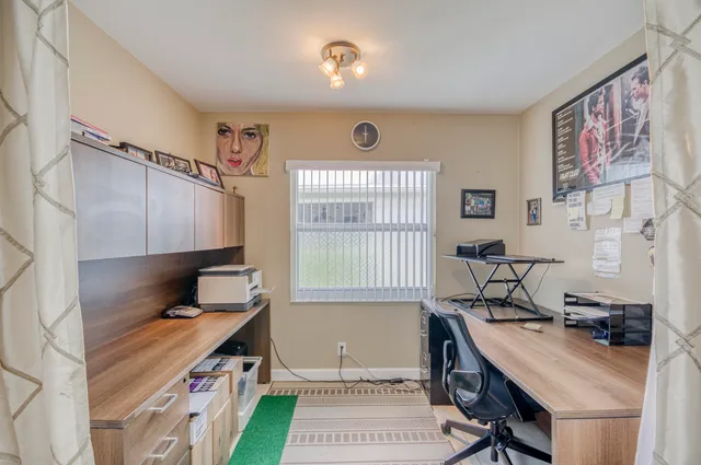 a view of a dining room with furniture a chandelier and wooden floor