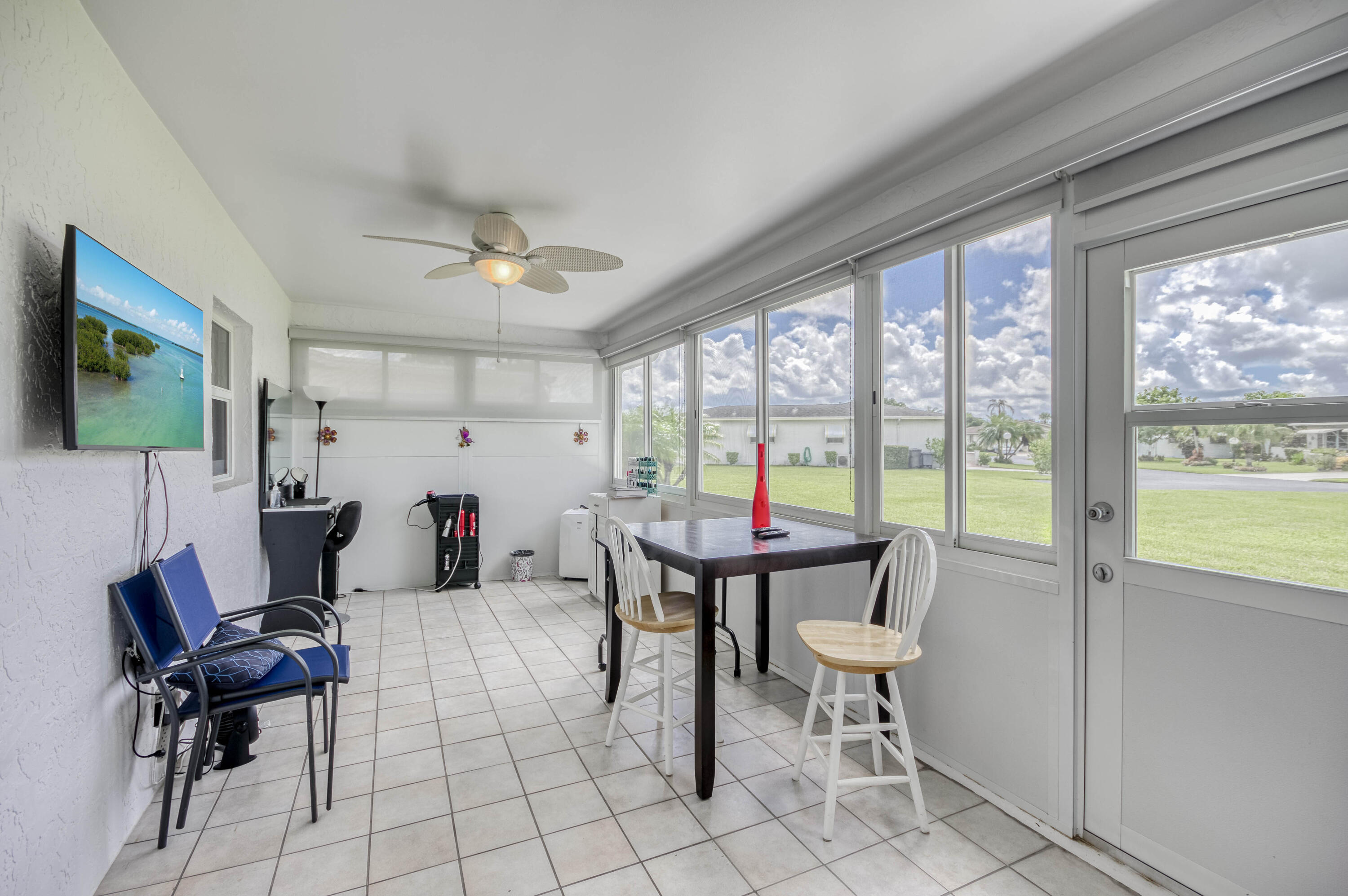 5398 Belleville Road West Palm Beach, FL 33417 - Photo 18 of 25 a view of a dining room with furniture a chandelier and wooden floor