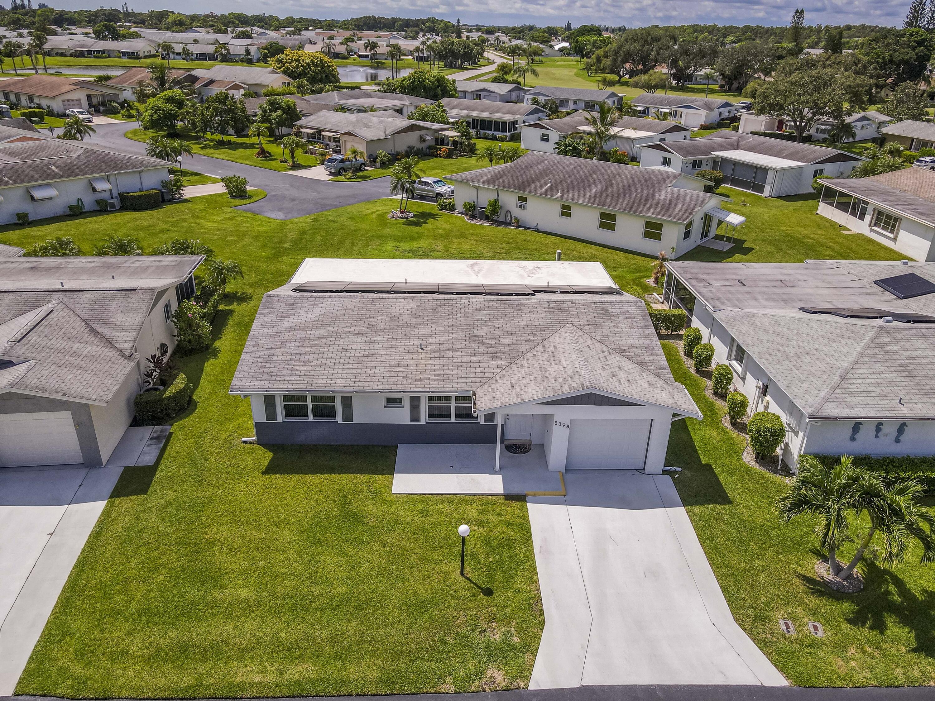 5398 Belleville Road West Palm Beach, FL 33417 - Photo 2 of 25 an aerial view of a house with a garden and lake view