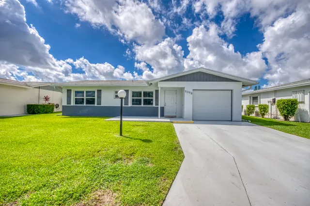 a house with swimming pool in front of it