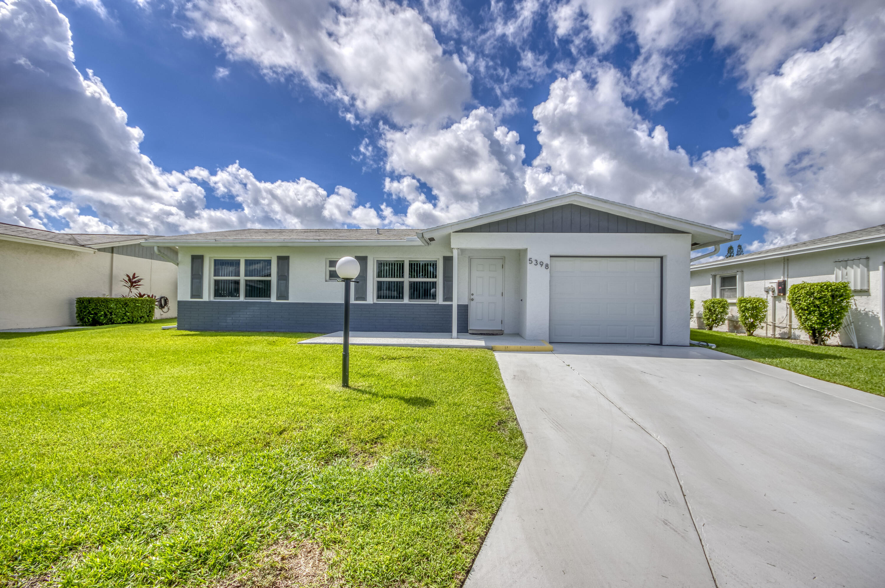 5398 Belleville Road West Palm Beach, FL 33417 - Photo 3 of 25 a house with swimming pool in front of it