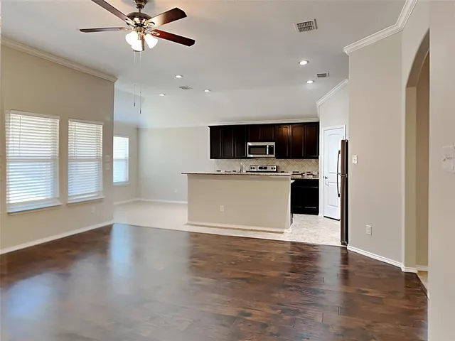 a view of a kitchen with a microwave and a sink