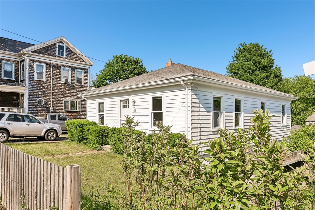 42 East Main Street Gloucester, MA 01930 - Photo 13 of 25 a front view of a house with a yard