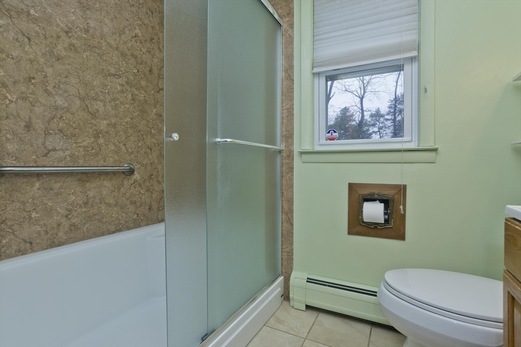 14 Tumbleweed Road Springfield, MA 01109 - Photo 23 of 28 a bathroom with a toilet and a painting on the wall