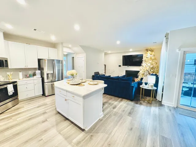 a kitchen with a sink microwave and wooden floor