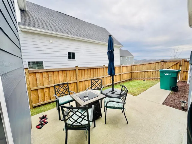 a balcony with table and chairs
