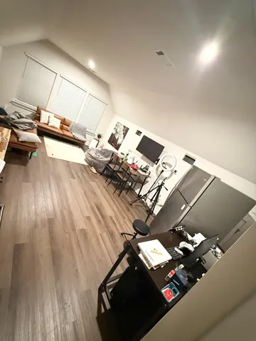 a view of a room with wooden floor