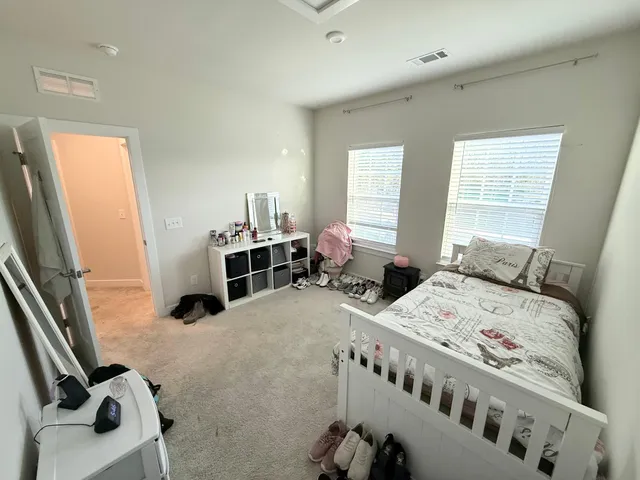 a bedroom with furniture and a large window