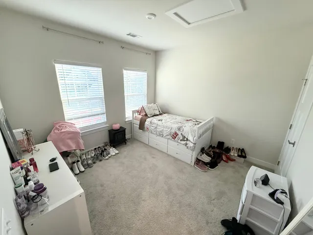 a bedroom with bed and a window