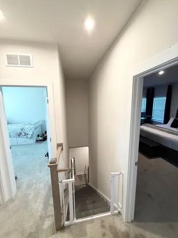 a view of a hallway and a livingroom with furniture