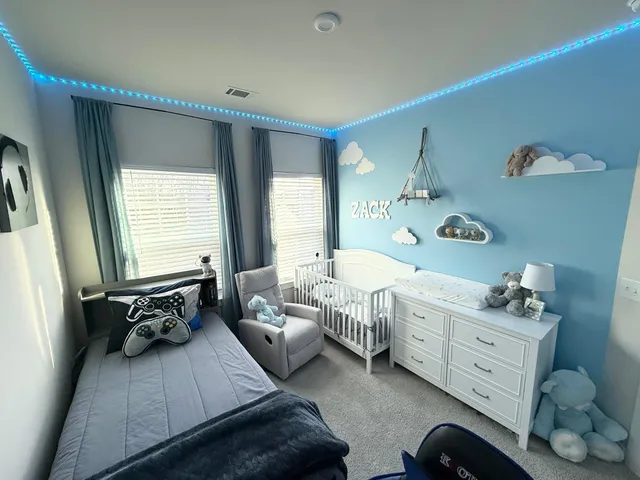 a spacious bedroom with a bed and a window