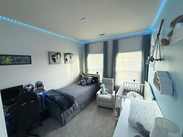 a living room with a bed furniture and a window