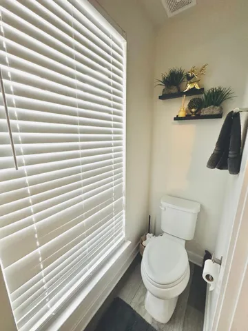 a white toilet sitting next to a bathroom sink