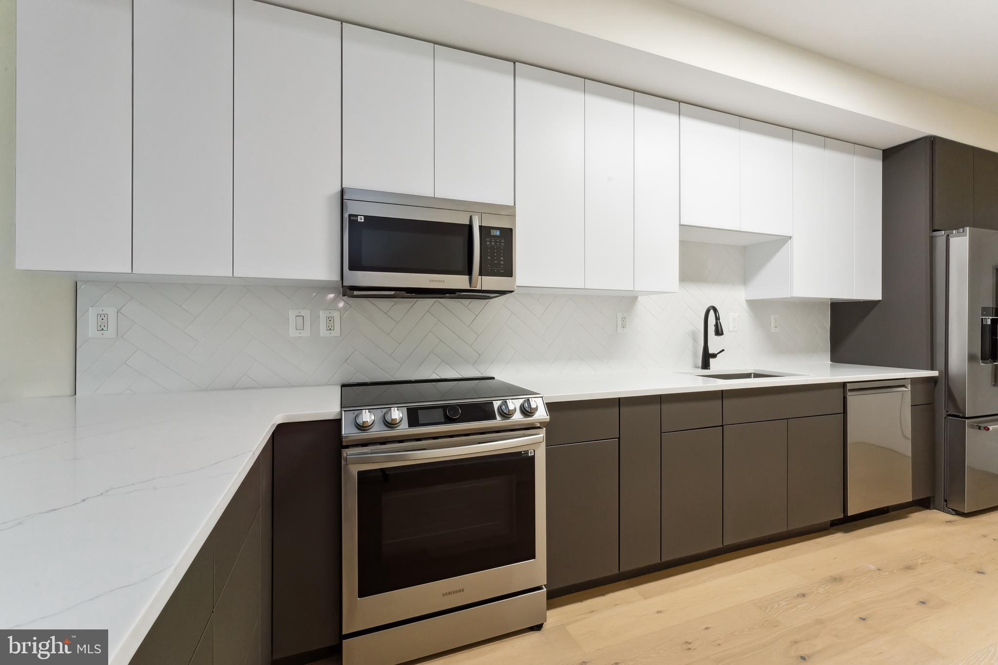 329 16th Street Southeast Washington, DC 20003 - Photo 12 of 39 a kitchen with cabinets appliances a sink and a counter top