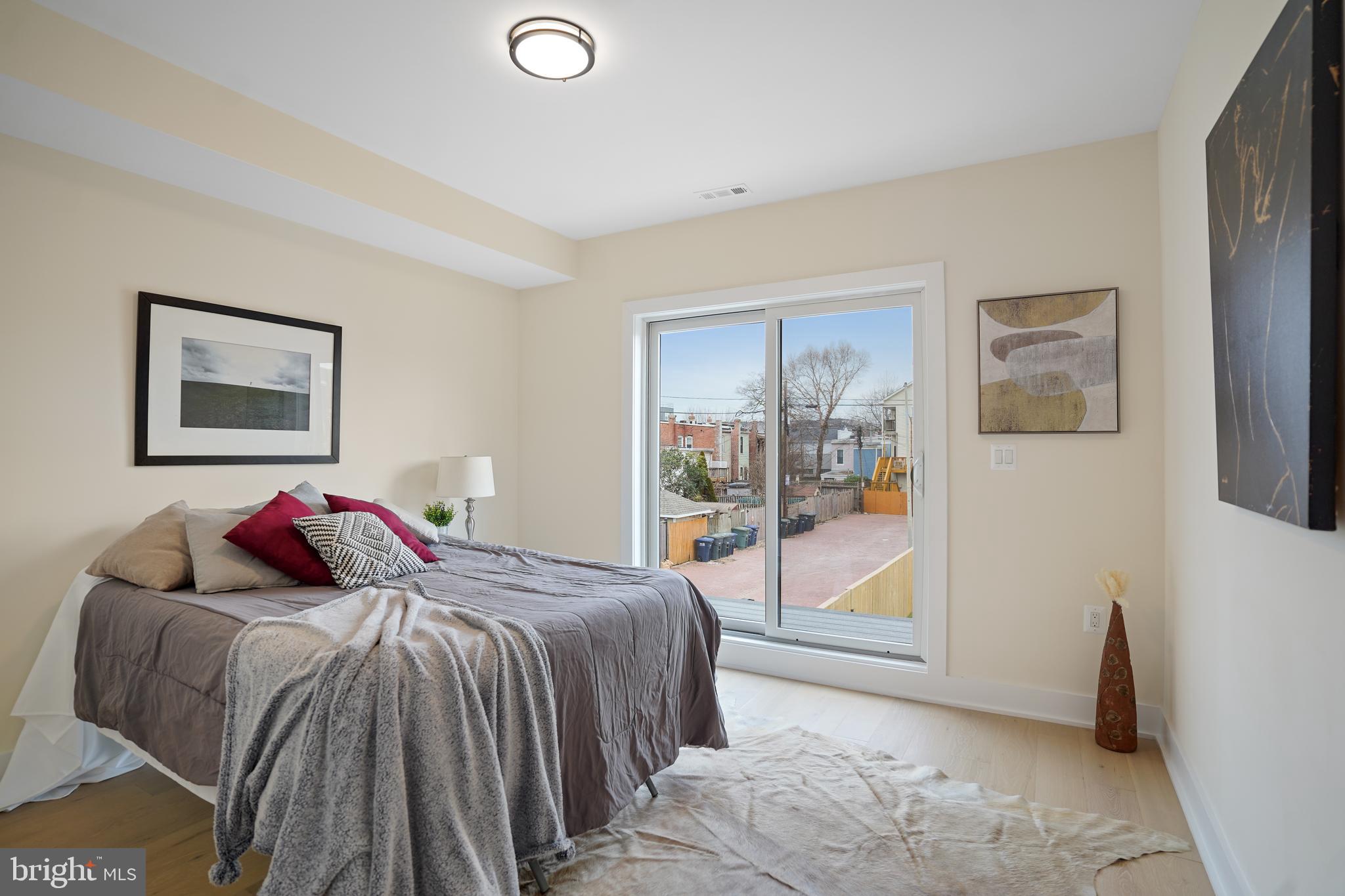 329 16th Street Southeast Washington, DC 20003 - Photo 16 of 39 a bedroom with a bed and glass door