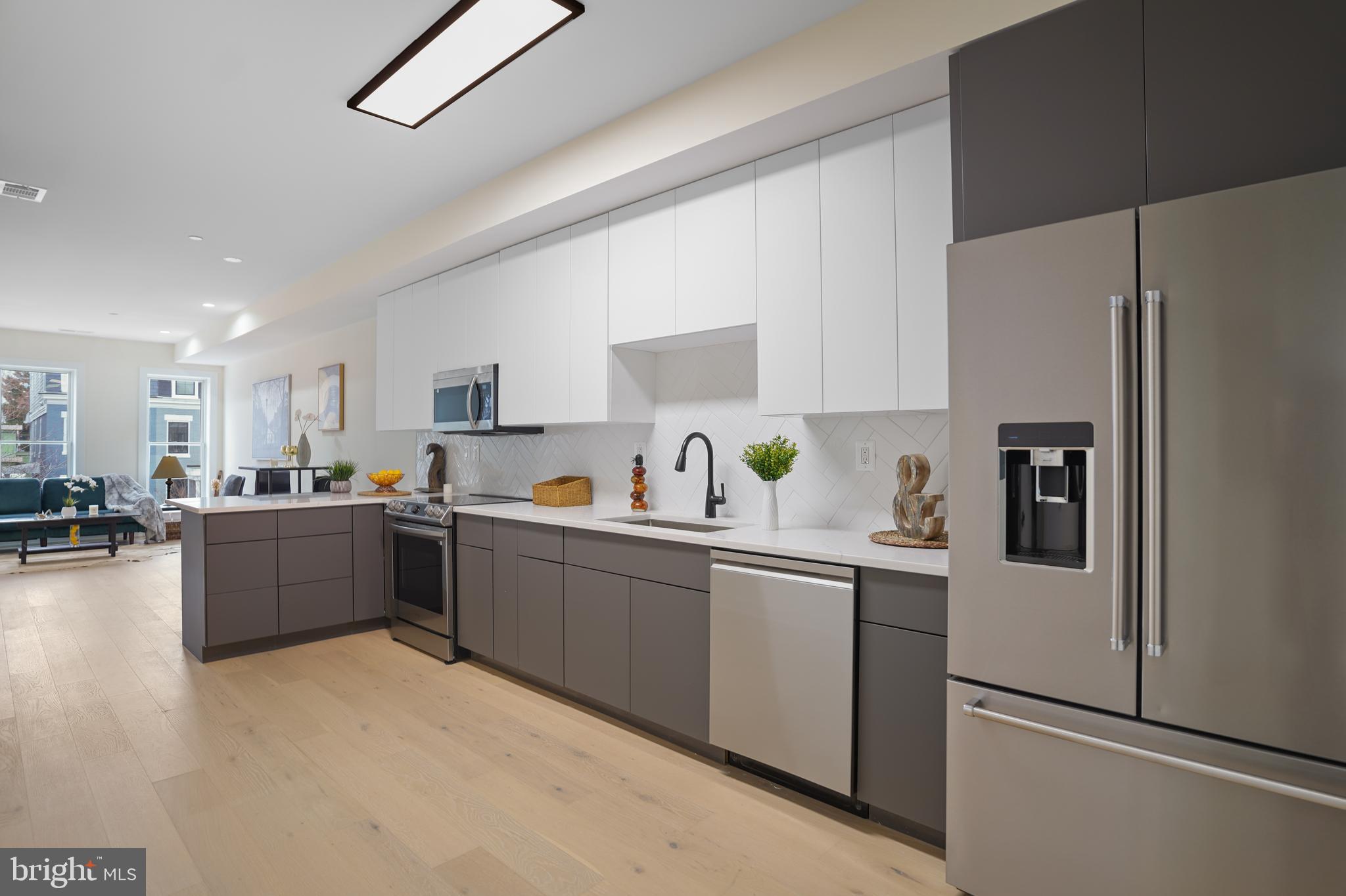 329 16th Street Southeast Washington, DC 20003 - Photo 9 of 39 a kitchen with stainless steel appliances a refrigerator sink and cabinets