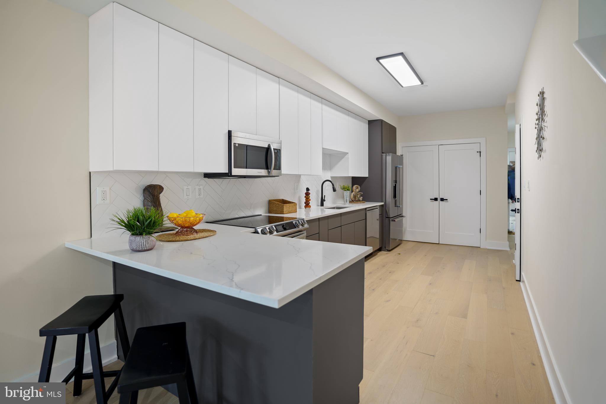 329 16th Street Southeast Washington, DC 20003 - Photo 10 of 39 a kitchen with a sink cabinets and wooden floor