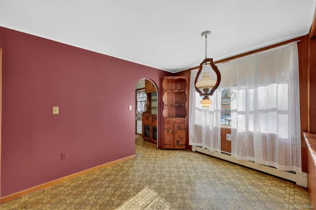 a living room with stainless steel appliances kitchen island granite countertop a refrigerator and a sink
