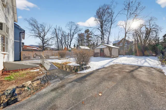 a view of a house with a snow in the yard