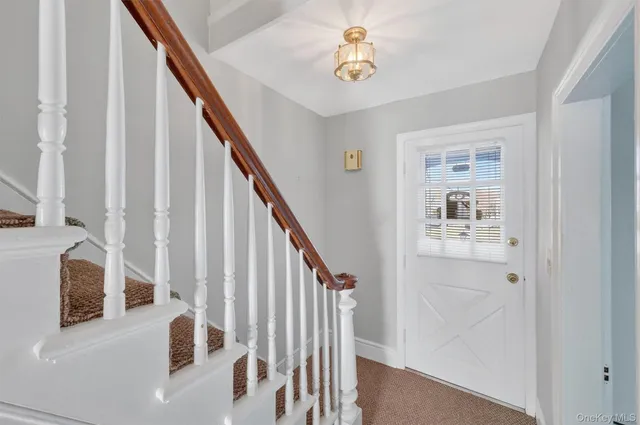 a view of staircase with wooden floor and fan