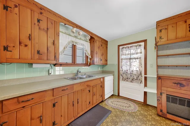 a kitchen with stainless steel appliances granite countertop a sink a stove and cabinets