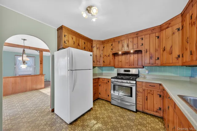a view of an entryway with wooden floor and mirror