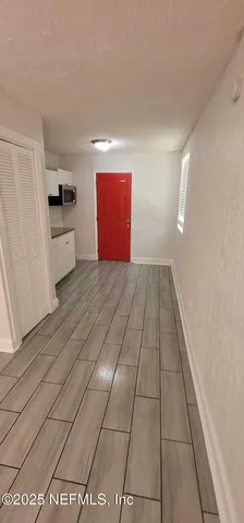 a view of a kitchen with a sink and a stove top oven
