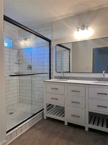 a bathroom with a shower and a sink