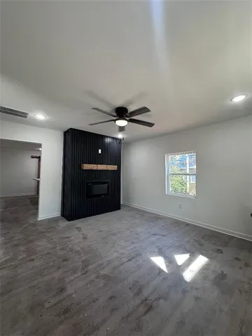 a view of a livingroom with a ceiling fan and window