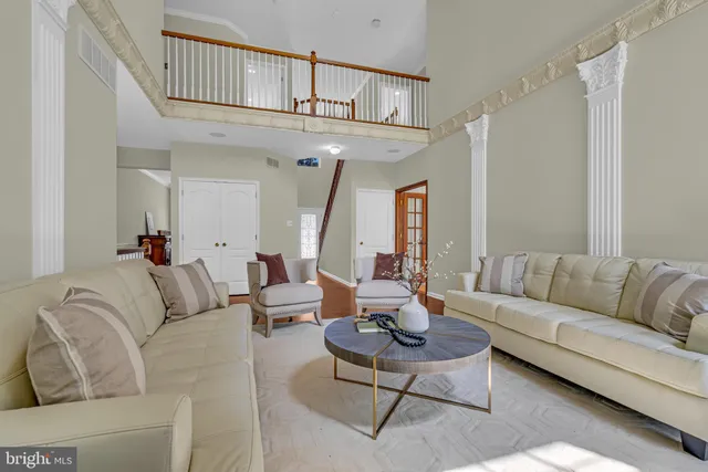 a living room with furniture a rug and a chandelier