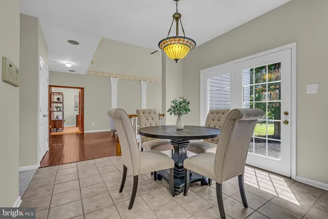 a view of a dining room with furniture and chandelier