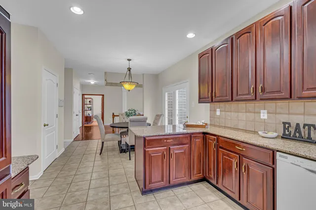 a kitchen with a sink dishwasher stove and cabinets