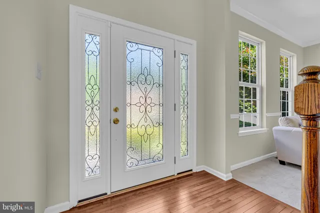 a view of an entryway with wooden floor and a window