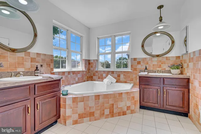 a spacious bathroom with a granite countertop sink a mirror and a window