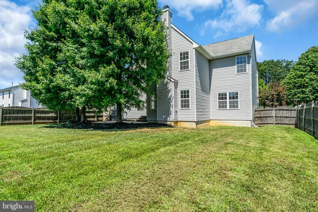 a house with huge green field in front of it