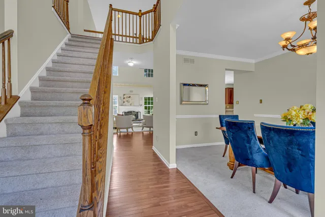 a dining room with furniture and wooden floor