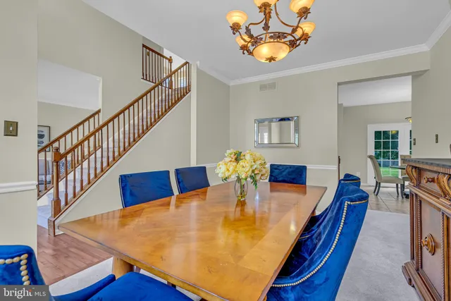 a dining room with furniture and wooden floor
