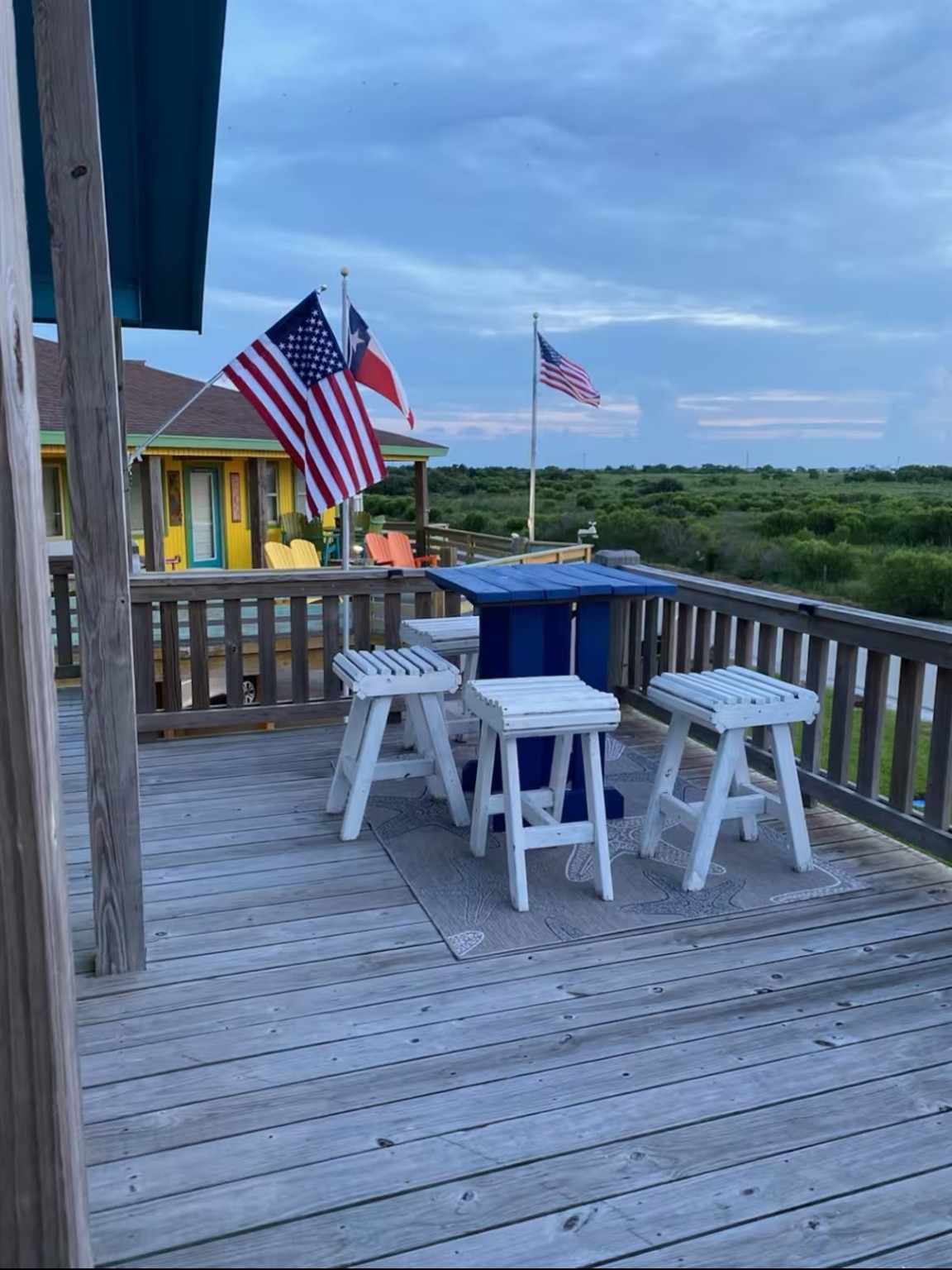 925 Honeysuckle Crystal Beach, TX 77650 - Photo 17 of 20 a view of a chairs and table on the wooden deck