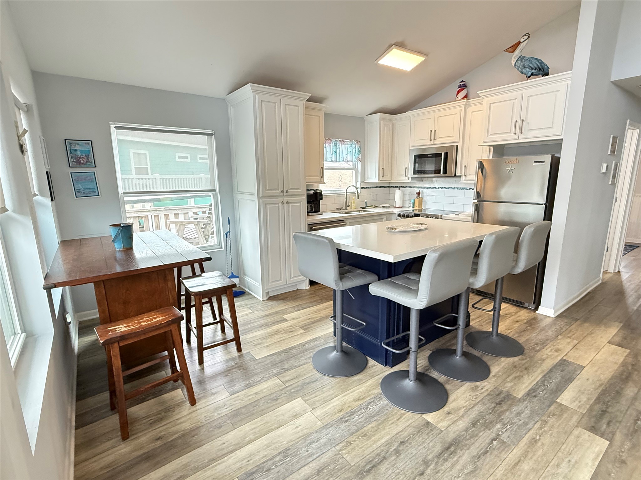 925 Honeysuckle Crystal Beach, TX 77650 - Photo 7 of 20 a view of kitchen with cabinets table and chairs
